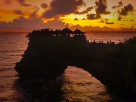 uma beleza do pôr do sol no templo tanah lot em bali. foto