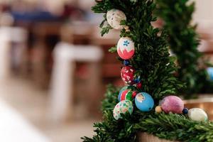 guirlanda de natal verde com enfeites em fundo brilhante ovos de páscoa foto