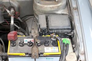 bateria e caixa de fusíveis na sala do motor do carro antigo foto