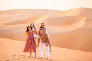 meninas entre dunas no deserto de rub al-khali nos Emirados Árabes Unidos foto