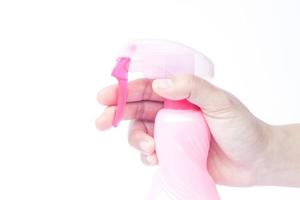 close-up de uma mão segurando um frasco de spray foto