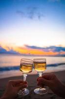 dois copos na praia de areia branca foto