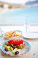 almoço tradicional com deliciosa salada grega fresca e brusqueta servido no almoço em restaurante ao ar livre com bela vista do mar e do porto