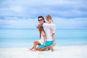 família linda feliz em umas férias de praia tropical foto