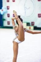 pequena ginasta treinando no tapete e pronta para competições foto