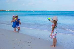 menina brincando com a família na praia foto