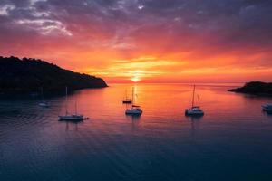 belo pôr do sol sobre o mar tropical e iate turístico na ilha de koh kood foto