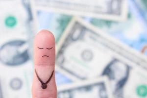 arte do dedo de um homem triste e solitário no fundo do dinheiro. foto