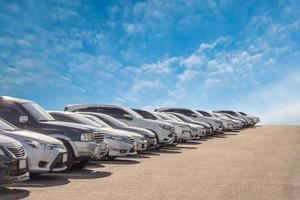 muito carro usado para venda em estoque com céu e nuvens foto