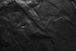 textura de sobreposição de embalagem de saco plástico transparente em fundo preto foto