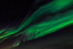 luzes verdes do norte e um céu estrelado sobre a cidade de nuuk, groenlândia foto