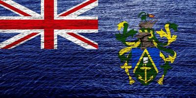 bandeira do território ultramarino britânico das ilhas pitcairn em um plano de fundo texturizado. colagem de conceito. foto