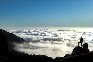 olhe o horizonte em um mar de nuvens do alto das montanhas foto