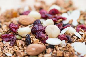 comida saudável de café da manhã fechada e borrada, granola, musli, aveia orgânica, super comida com mel, frutas secas e nozes foto