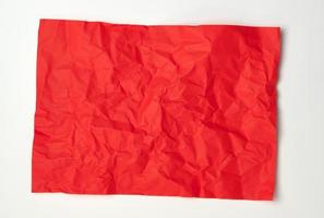 folha de papel retangular vermelha amassada em um fundo branco foto