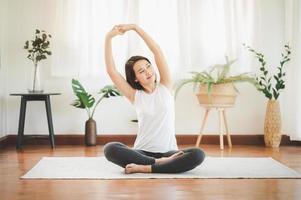 mulher fazendo yoga em casa foto