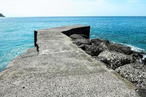 cais de pedra no mar foto