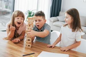 construindo uma torre. Jogando. crianças se divertindo na sala de casa durante o dia juntos foto