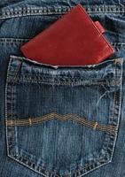 carteira de couro marrom no bolso de trás da calça jeans foto
