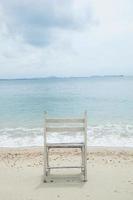 cadeira de madeira branca no mar foto