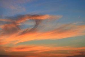 pôr do sol lindo colorida crepúsculo dentro azul céu e nuvem suave foto