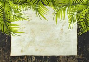 folhas de palmeira com papel em uma mesa de madeira foto
