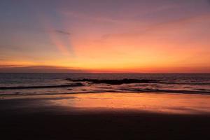 lindo pôr do sol céu às natai de praia foto