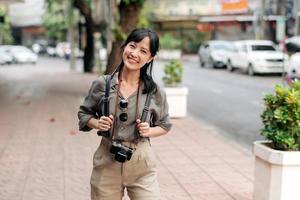 jovem ásia mulher mochila viajante desfrutando rua cultural local Lugar, colocar e sorriso. foto