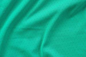 tecido de roupas esportivas verde camisa de futebol camisa de fundo de textura foto