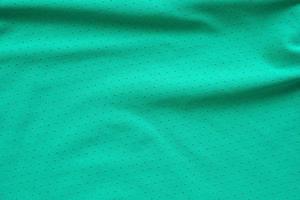 tecido de roupas esportivas verde camisa de futebol camisa de fundo de textura foto