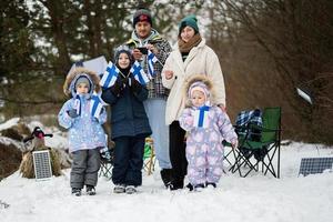 finlandês família com Finlândia bandeiras em uma agradável inverno dia. nórdico escandinavo pessoas. foto