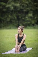 mulher fazendo ioga no parque foto