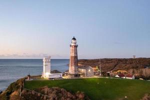 Montauk farol e de praia às nascer do sol, grandes ilha, Novo Iorque, EUA. foto