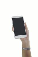 mão de uma mulher segurando um telefone branco sobre fundo branco foto