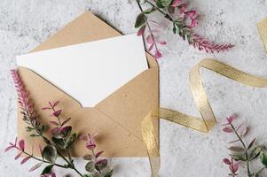 envelopes e lindo flores em mármore fundo foto