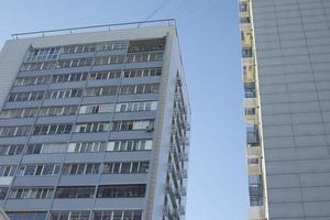 cinzento construção dentro cidade. Alto casa. janelas dentro residencial prédio. foto