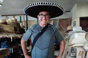 turista com mexicano sombrero vaca Garoto chapéu fazer compras foto