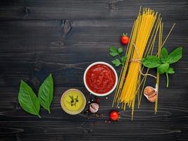 Ingredientes do espaguete no fundo escuro de madeira