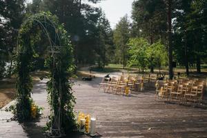 arco de casamento é decorado com folhas verdes e limões. foto