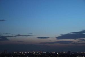 Sombrio azul nuvem com branco luz pôr do sol céu fundo e cidade luz meia noite tarde Tempo foto