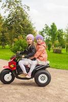 pequeno meninas em uma elétrico motocicleta foto