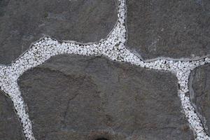 Preto basalto pedra com polar branco mármore cascalho foto