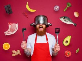 homem chefe de cozinha é pronto para luta dentro a cozinha. Borgonha fundo foto