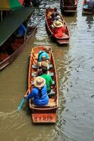 barcos vendendo frutas às a flutuando mercado é uma popular turista destino este europeus e chinês pessoas gostar para viagem com tradicional Vila vida.-10-8-2014-damnoen Saduak Ratchaburi foto