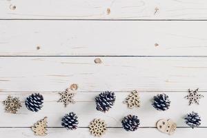 de madeira branco e Natal fundo com flocos de neve, pinho cones e Natal decoração. foto