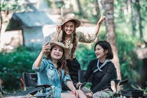 namorada e mulher bonita asiática usam selfie de smartphone no acampamento foto