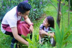 pai ensinando filha a jardinar