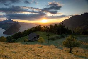 uma panorama tiro a partir de uma montanha negligenciar uma lago durante a dourado hora foto