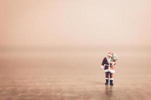 miniatura do papai noel carregando uma sacola, conceito de celebração de natal foto