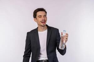 retrato de jovem feliz mostrando água em uma garrafa isolada sobre fundo branco foto